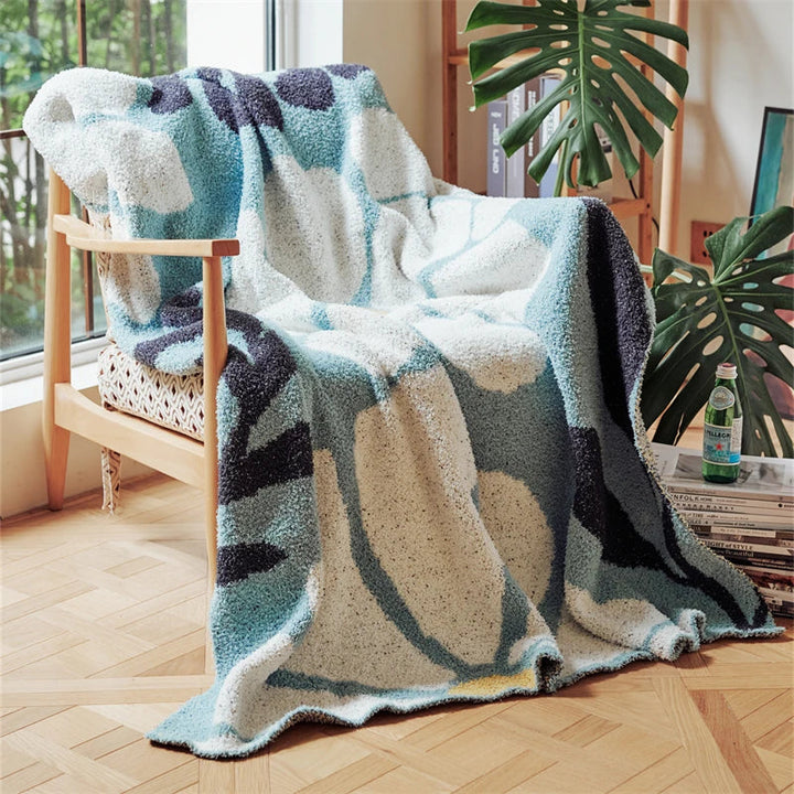 Strikket boho-pledd med blader og blomster i mikrofiber