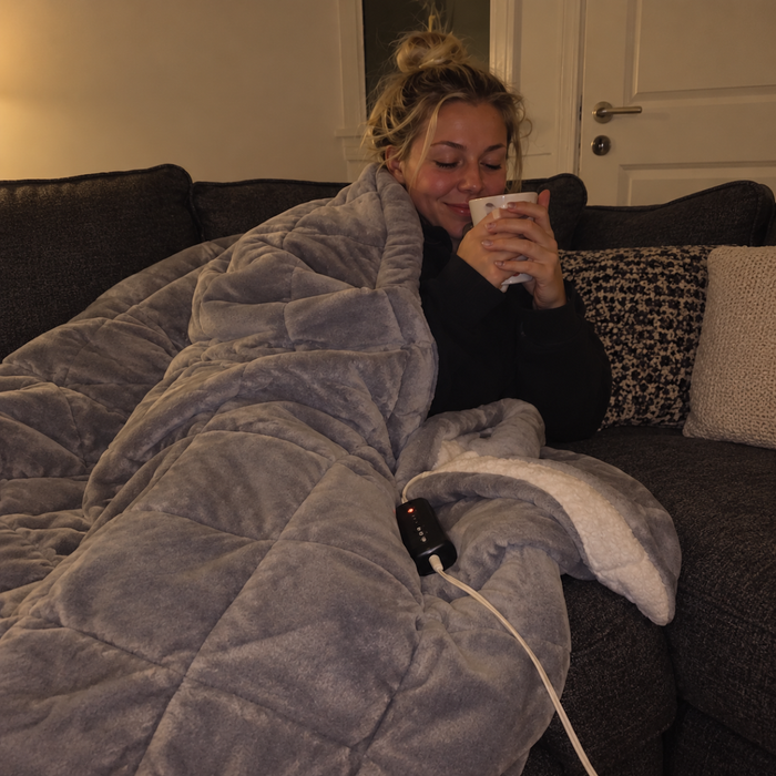 Te, sofa og et varmeteppe